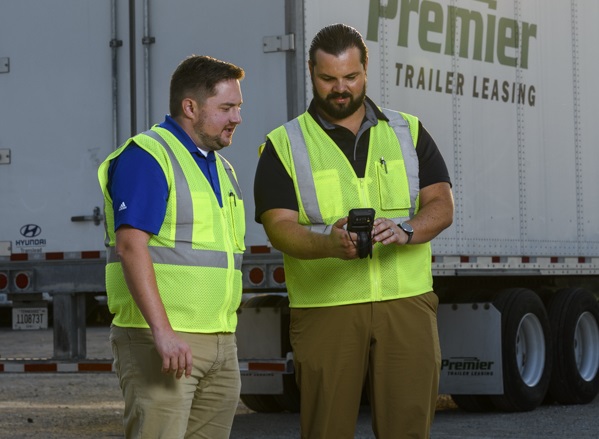 Two employees utilizing remote trailer tracking on their fleet